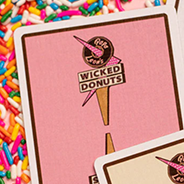 Papa Leon's Wicked Donuts (Strawberry) Playing Cards by Wounded Corner and Cam Toner